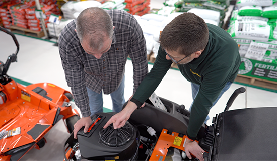 team member helping a customer with a mower purchase