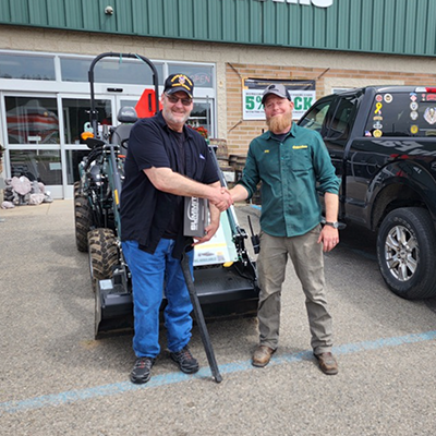 FFH Employee shaking customers hand after Summit Tractor Purchase